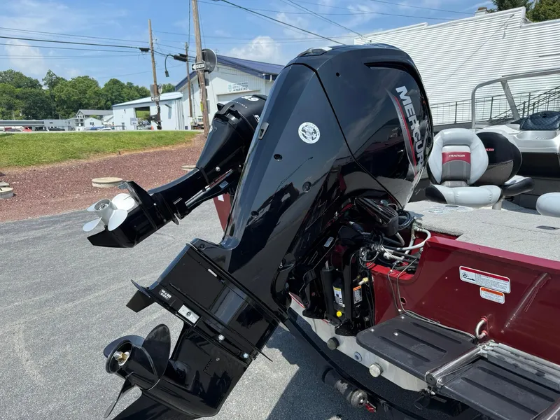 Slide: The Image of 2012 Tracker Targa V-18 Combo boat with Mercury outboard motor, parked outdoors. - 4