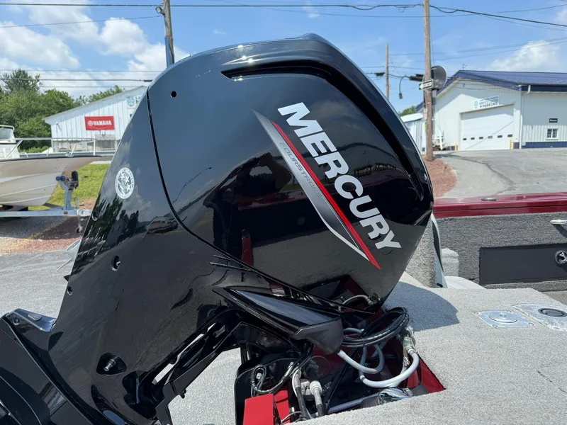 Slide: The Image of 2012 Tracker Targa V-18 Combo with Mercury outboard motor, parked outdoors. - 5