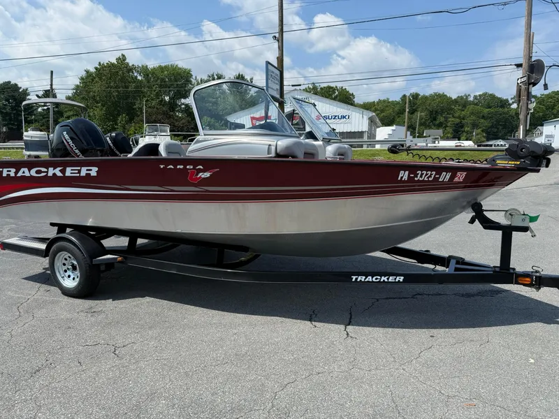 Slide: The Image of 2012 Tracker Targa V-18 Combo boat on trailer, parked outdoors under a cloudy sky. - 7
