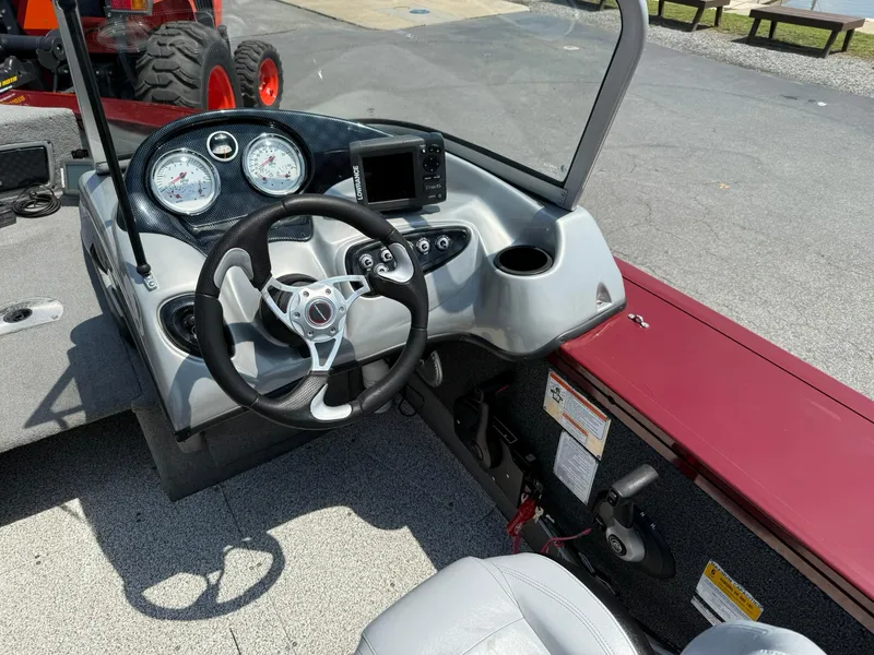 Slide: The Image of 2012 Tracker Targa V-18 Combo boat dashboard with steering wheel and gauges. - 9