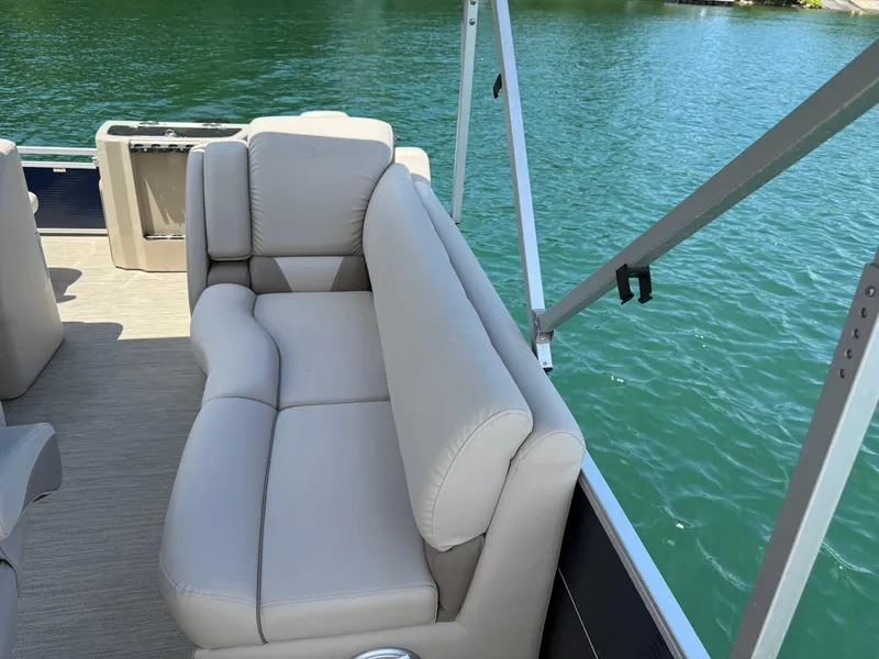 Slide: The Image of 2017 Silver Wave 230 Island CC boat with beige seating, on a calm lake. - 10