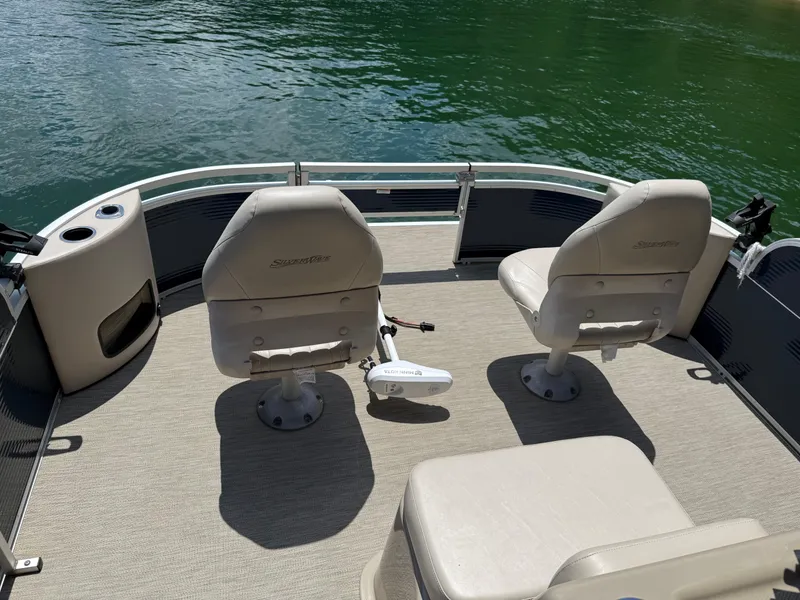 Slide: The Image of 2017 Silver Wave 230 Island CC boat interior with two seats and water view. - 11