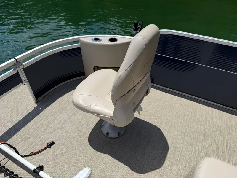 Slide: The Image of 2017 Silver Wave 230 Island CC boat seat with beige upholstery on deck by water. - 12