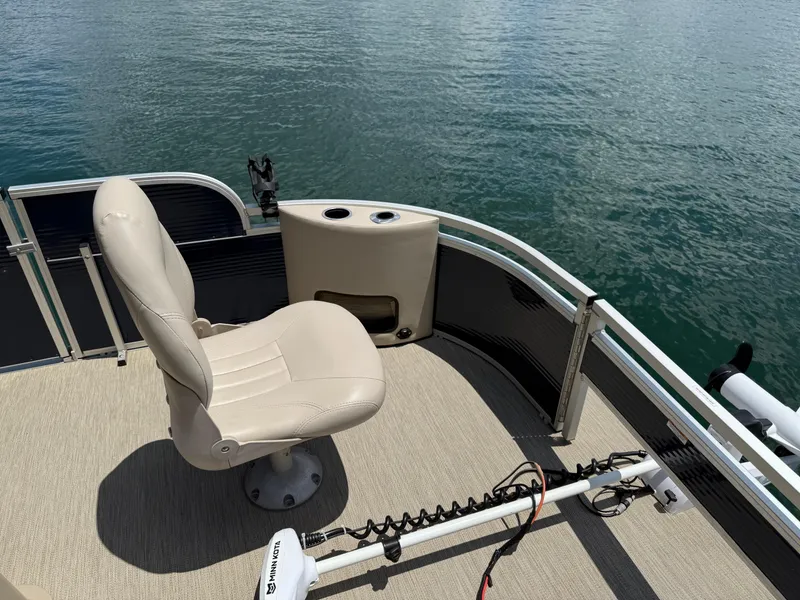 Slide: The Image of 2017 Silver Wave 230 Island CC boat interior with beige seat and water view. - 13