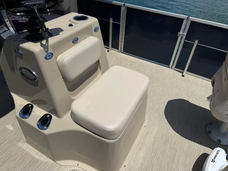 Slide: The Image of 2017 Silver Wave 230 Island CC boat interior with beige seating and control panel. - 14