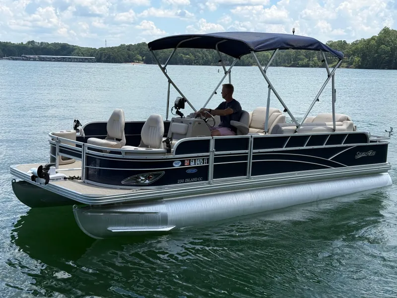Slide: The Image of 2017 Silver Wave 230 Island CC pontoon boat on a lake with a canopy. - 2