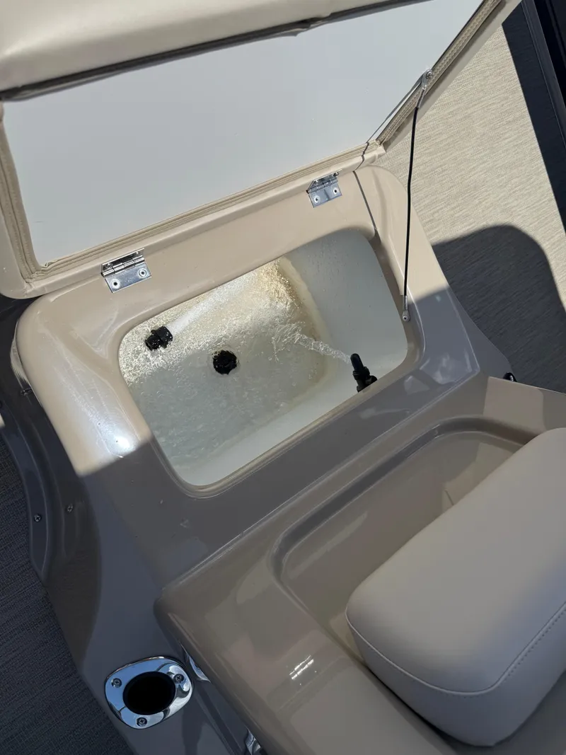 Slide: The Image of Livewell compartment on a 2017 Silver Wave 230 Island CC boat, open with water inside. - 24