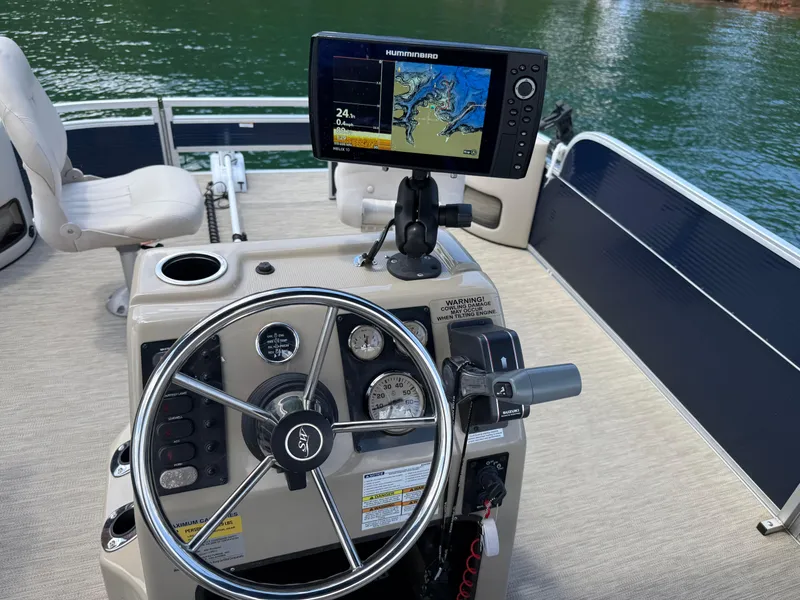 Slide: The Image of Steering console of 2017 Silver Wave 230 Island CC boat with navigation display. - 27
