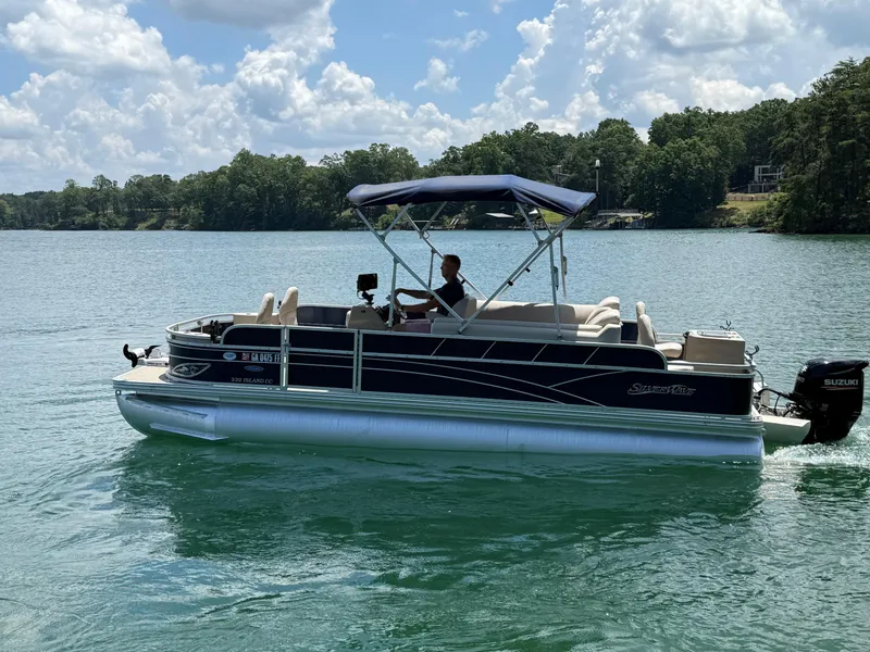 Slide: The Image of 2017 Silver Wave 230 Island CC pontoon boat cruising on a sunny lake. - 3