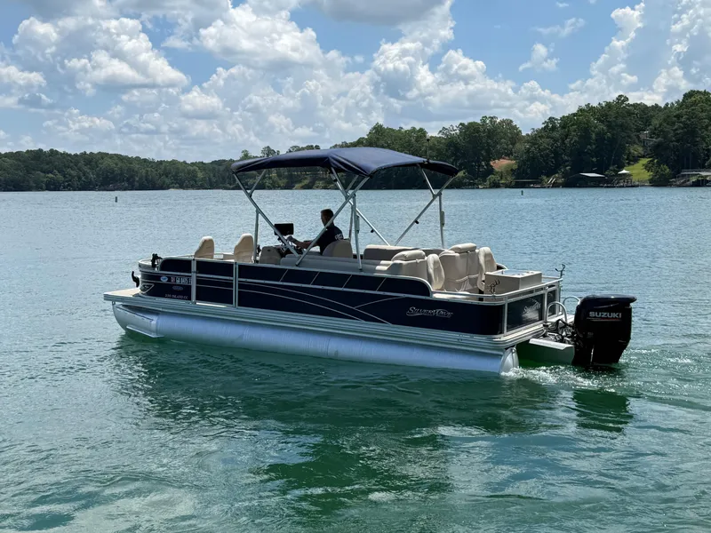 Slide: The Image of 2017 Silver Wave 230 Island CC pontoon boat cruising on a sunny lake. - 4