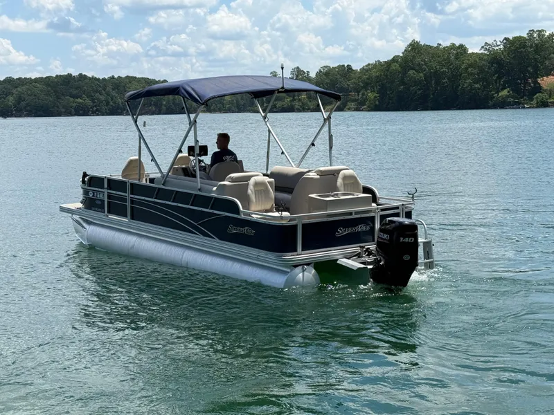 Slide: The Image of 2017 Silver Wave 230 Island CC pontoon boat cruising on a lake. - 5
