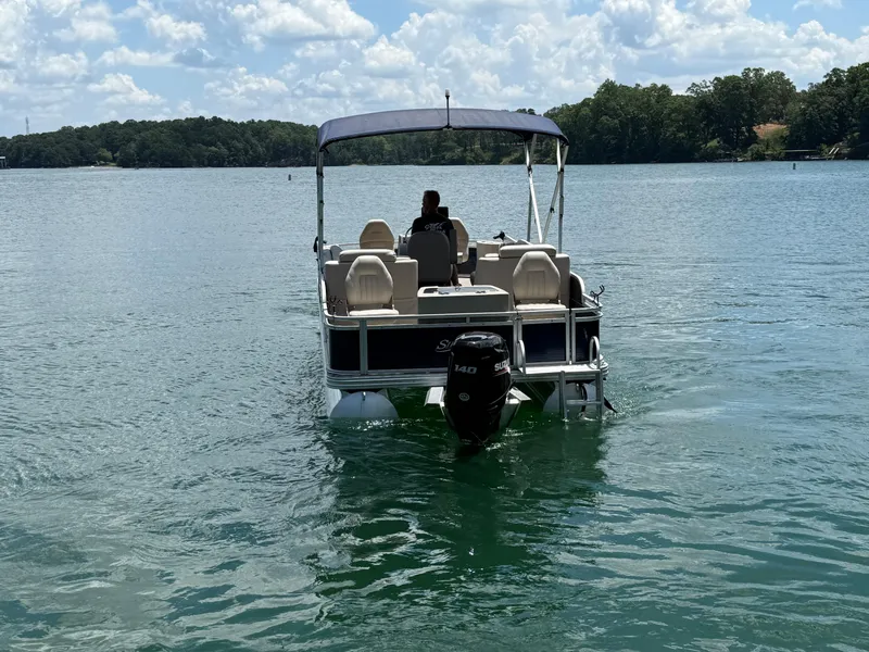 Slide: The Image of 2017 Silver Wave 230 Island CC boat on a lake under a cloudy sky. - 6