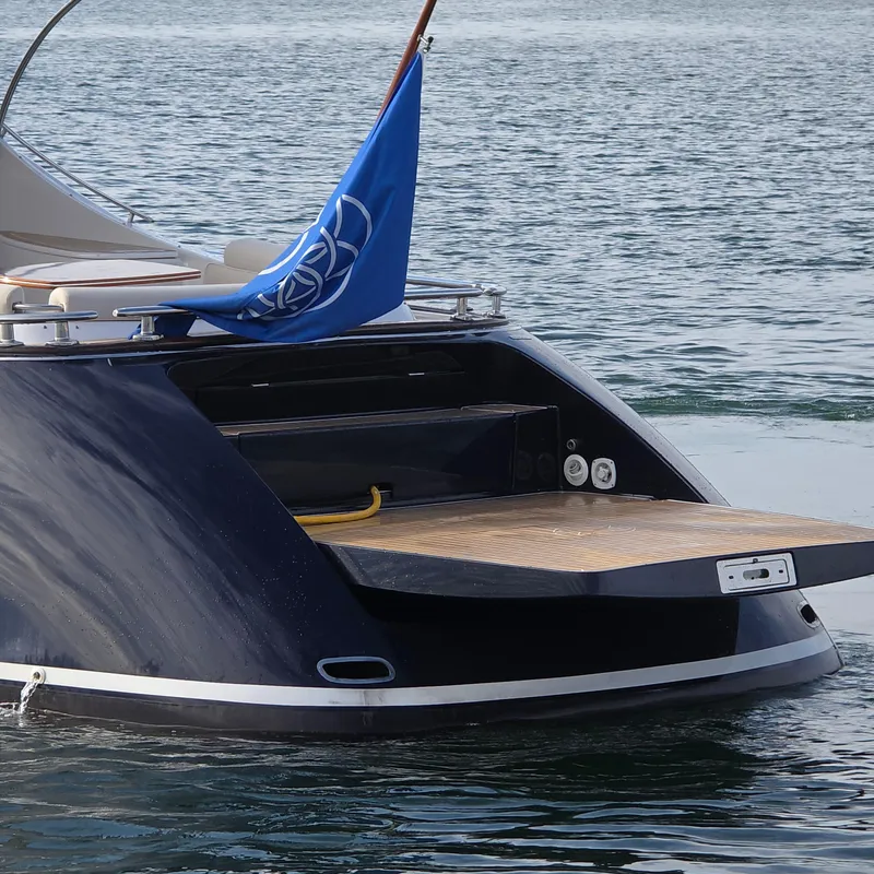 Slide: The Image of 2013 Zeelander Z44 yacht with blue flag, docked on calm water. - 14