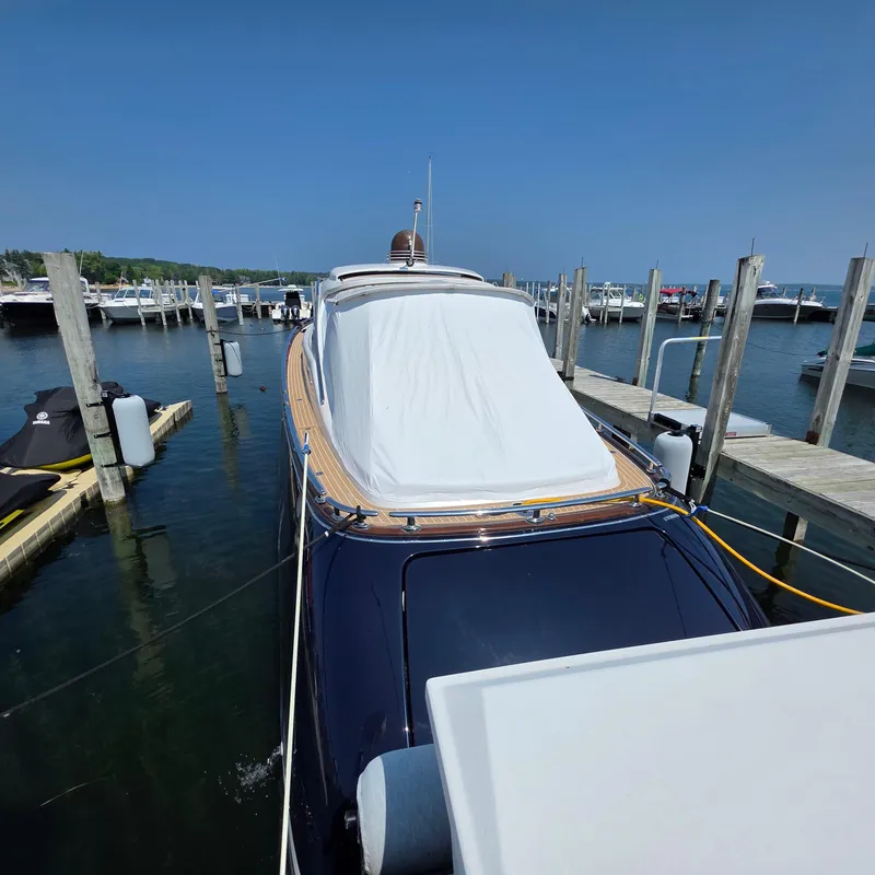 Slide: The Image of 2013 Zeelander Z44 yacht docked at marina, covered deck, clear blue sky. - 15