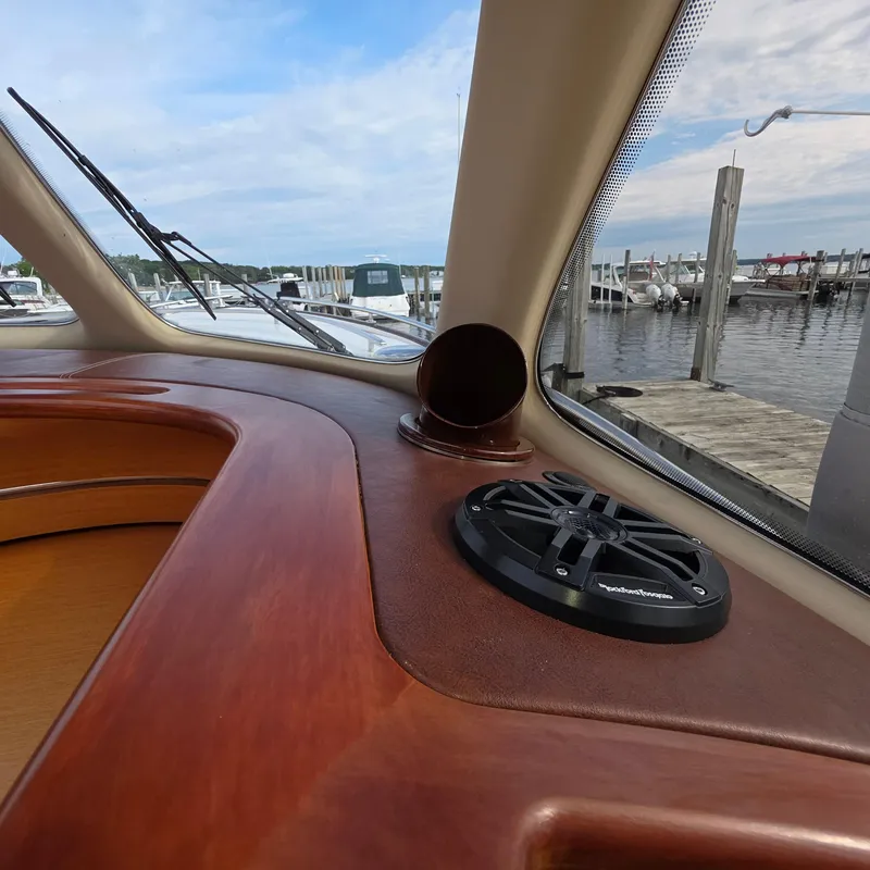 Slide: The Image of Interior view of 2013 Zeelander Z44 yacht dashboard with speaker and marina background. - 25