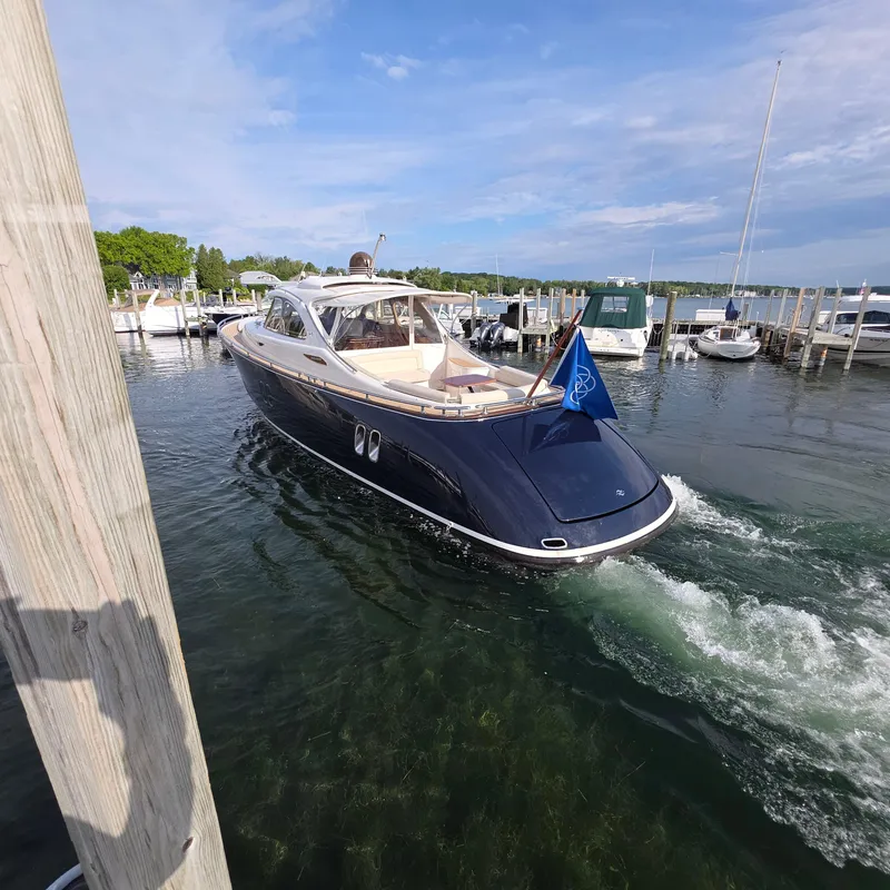 Slide: The Image of 2013 Zeelander Z44 yacht cruising in a marina under a clear blue sky. - 28