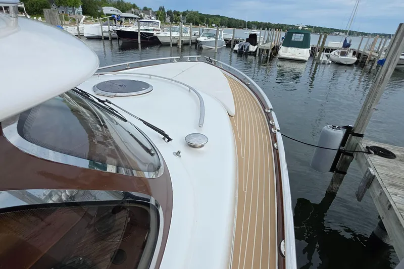 Slide: The Image of 2013 Zeelander Z44 yacht docked at a marina, showcasing sleek design and wooden deck. - 42