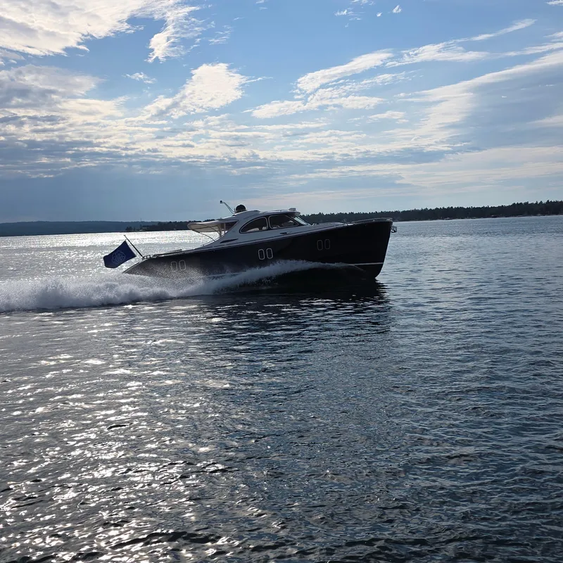 Slide: The Image of 2013 Zeelander Z44 yacht cruising on open water under a partly cloudy sky. - 43