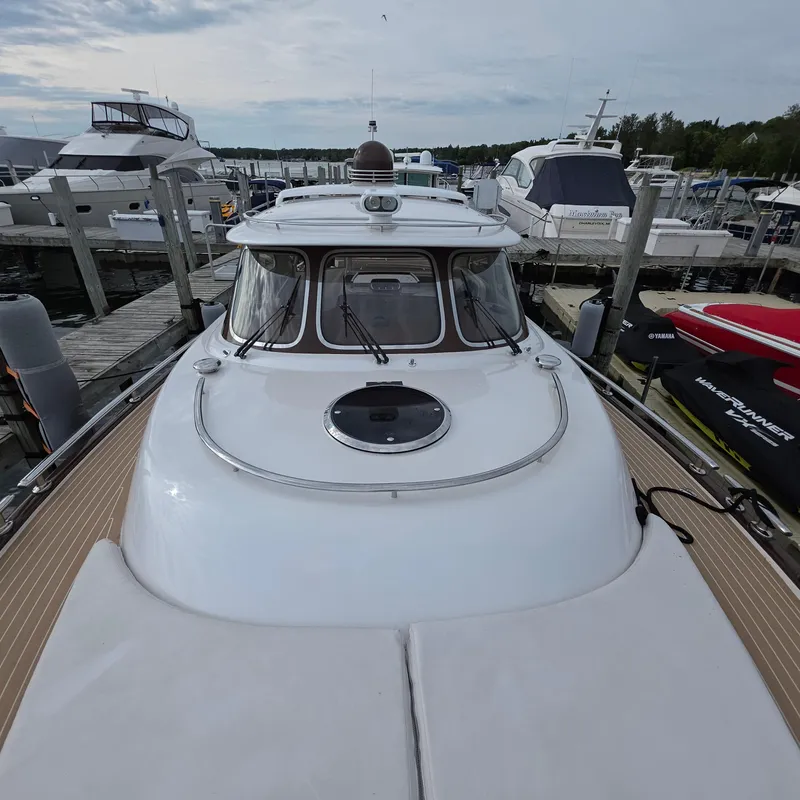Slide: The Image of 2013 Zeelander Z44 yacht docked at a marina, surrounded by other boats. - 44
