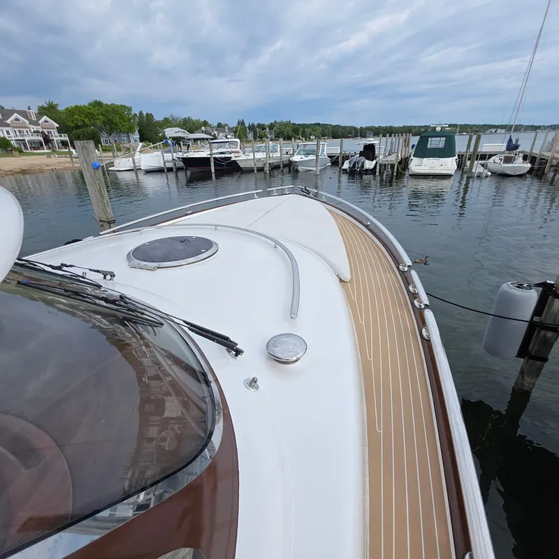 Slide: The Image of 2013 Zeelander Z44 yacht docked at a marina with scenic waterfront view. - 47