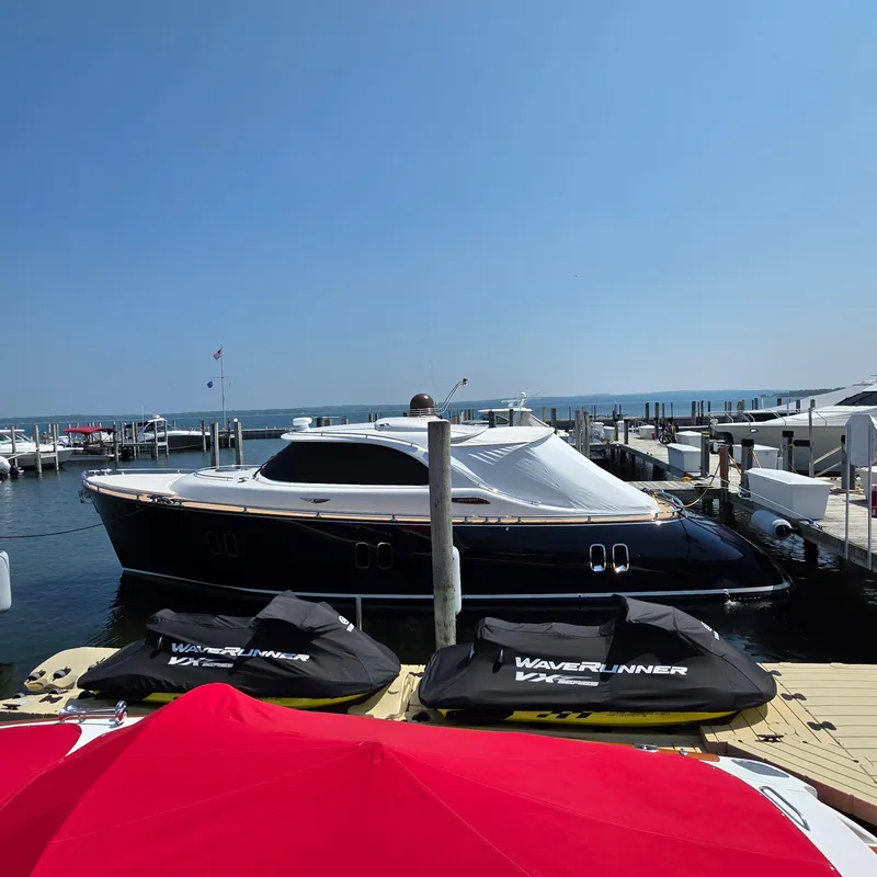 Slide: The Image of 2013 Zeelander Z44 yacht docked at marina with jet skis in foreground. - 6