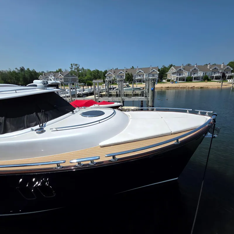 Slide: The Image of 2013 Zeelander Z44 yacht docked at a marina with waterfront homes in the background. - 7