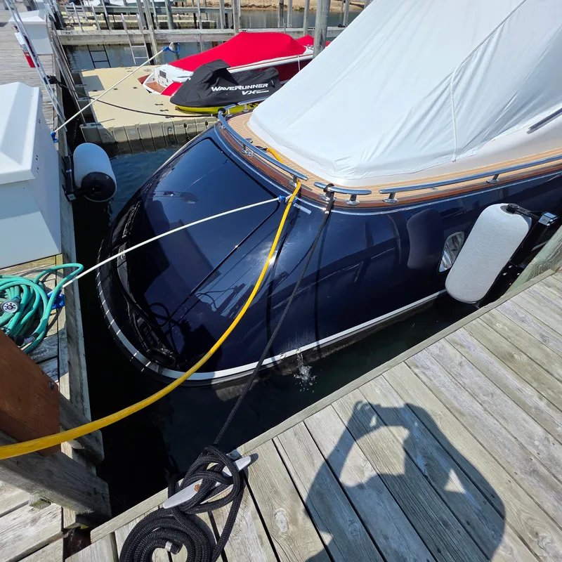 Slide: The Image of 2013 Zeelander Z44 yacht docked with protective cover and mooring lines. - 9