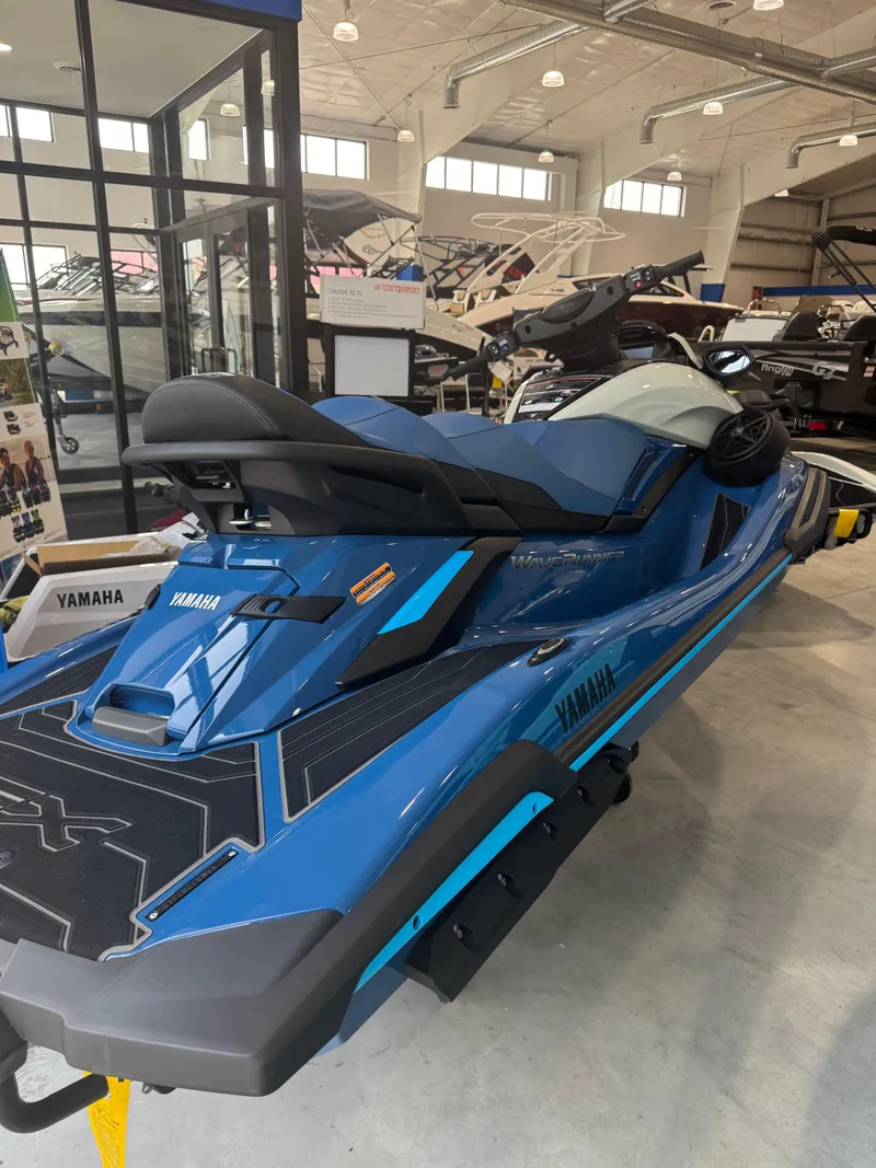 Slide: The Image of 2025 Yamaha WaveRunner FX Limited SVHO in showroom, blue color, sleek design. - 2