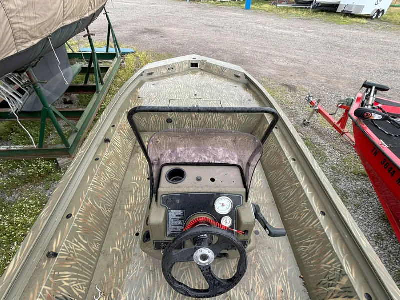 Slide: The Image of 2022 Tracker Grizzly 1860 CC boat interior with steering wheel and control panel. - 3