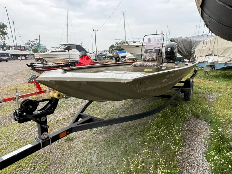 Slide: The Image of 2022 Tracker Grizzly 1860 CC boat on trailer in marina setting. - 5