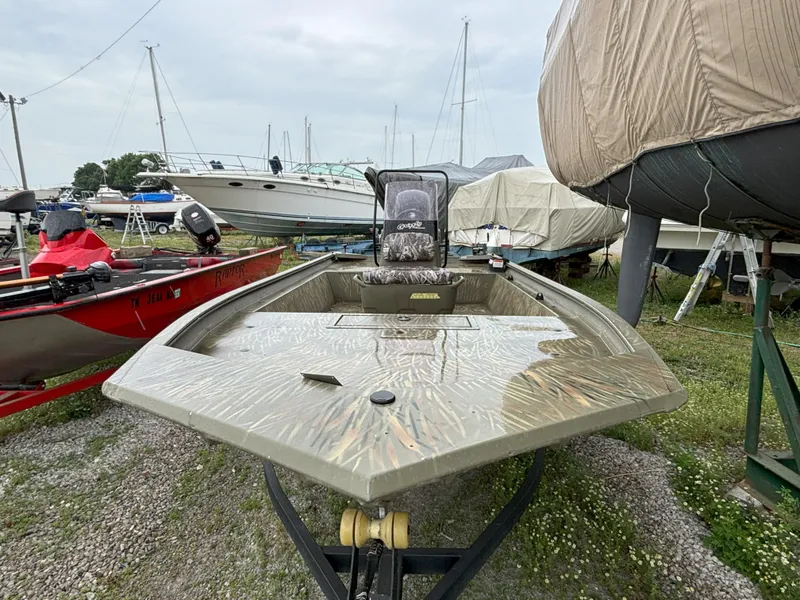 Slide: The Image of 2022 Tracker Grizzly 1860 CC boat on trailer in a marina storage area. - 6