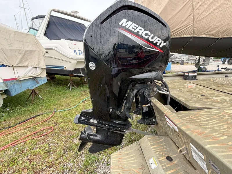Slide: The Image of 2022 Tracker Grizzly 1860 CC with Mercury outboard motor in a boatyard. - 7