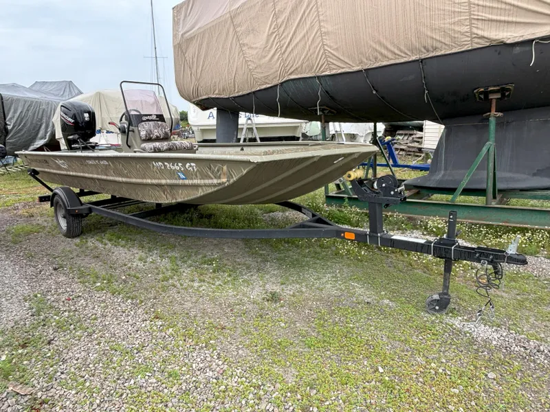Slide: The Image of 2022 Tracker Grizzly 1860 CC boat on trailer, parked outdoors. - 8