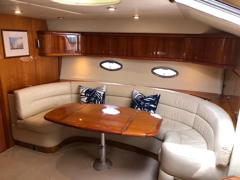 Slide: The Image of Luxurious interior of 2003 Sunseeker Portofino 46 yacht with elegant seating and wooden table. - 15