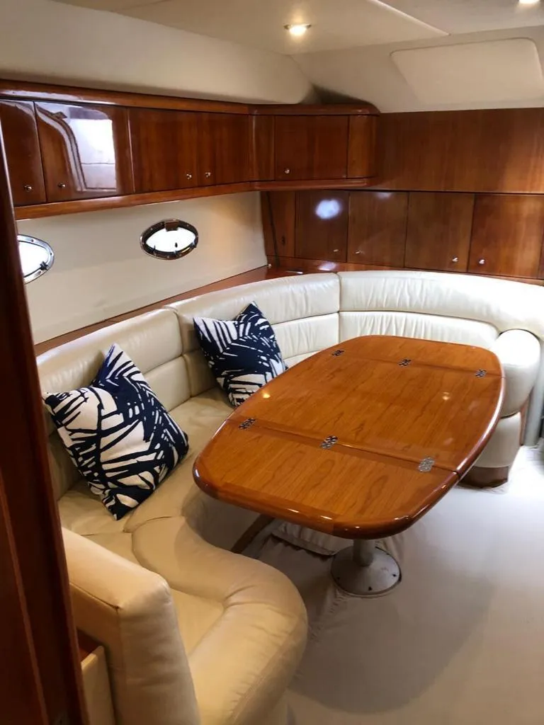 Slide: The Image of Luxurious Sunseeker Portofino 46 yacht interior with elegant wood and leather seating, 2003 model. - 24