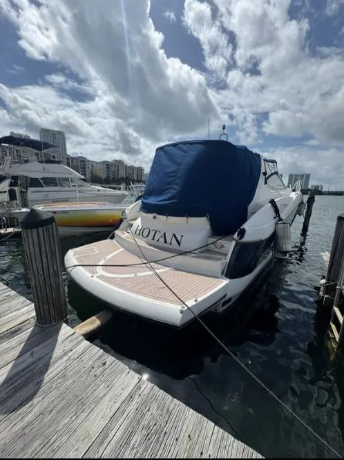 Slide: The Image of 2003 Sunseeker Portofino 46 yacht docked at marina under cloudy sky. - 4