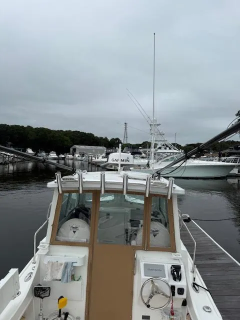 Slide: The Image of 2021 Steiger Craft 255 DV MIAMI boat docked at marina under cloudy sky. - 4