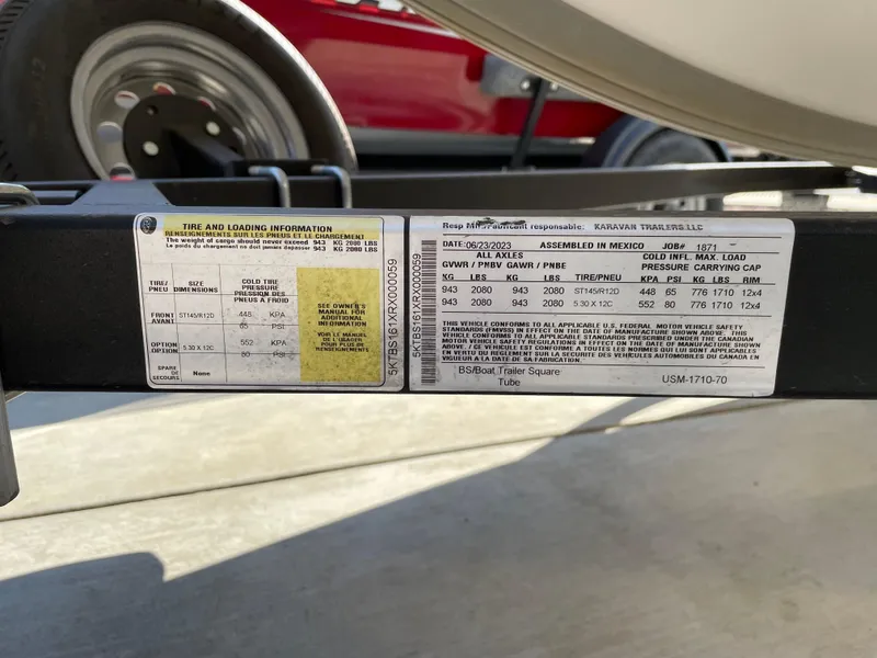 Slide: The Image of 2023 Bayliner Element M15 trailer label with tire and loading information. - 16