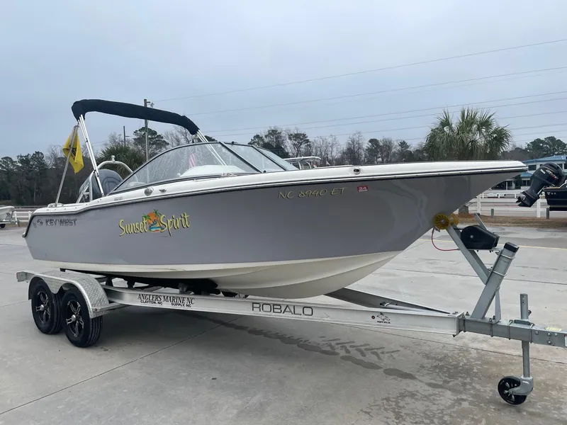 Slide: The Image of 2021 Key West 203 DFS boat on trailer, labeled "Sunset Spirit," parked outdoors. - 1