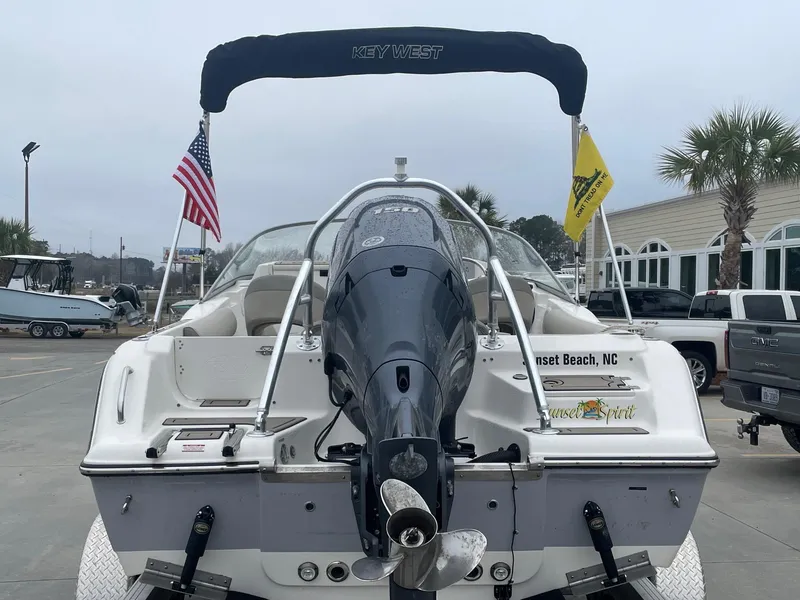 Slide: The Image of 2021 Key West 203 DFS boat with flags, parked at Sunset Beach, NC. - 3