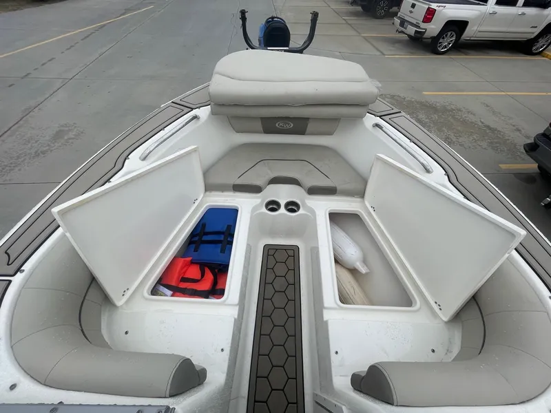 Slide: The Image of 2021 Key West 203 DFS boat interior with open storage compartments and seating. - 8