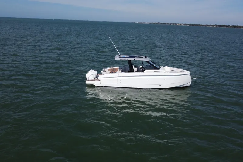 Slide: The Image of 2026 Beneteau Gran Turismo 35 yacht docked in a sunny marina setting. - 11