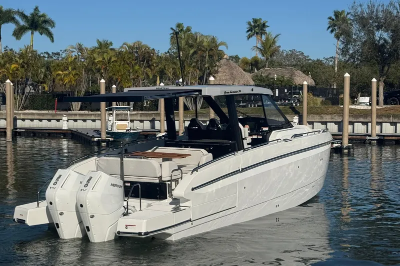 Slide: The Image of 2026 Beneteau Gran Turismo 35 yacht docked, featuring twin Mercury outboard engines. - 16