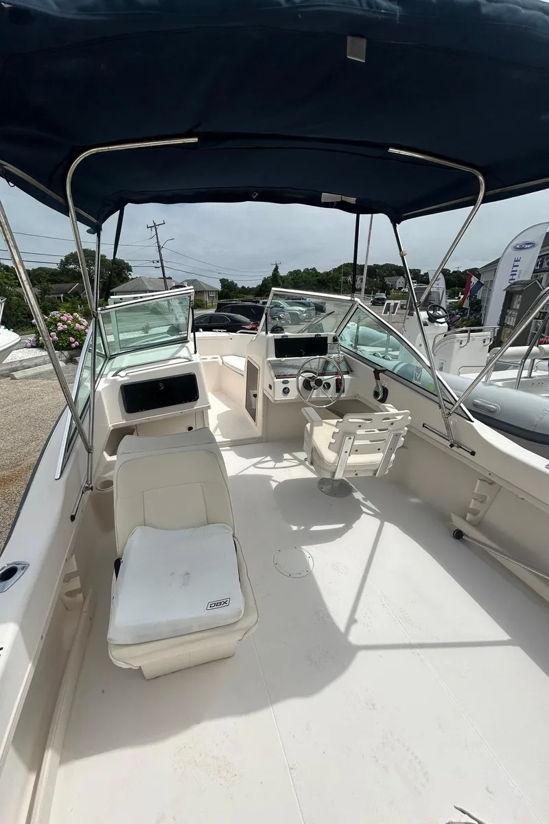 Slide: The Image of 1999 Grady-White 192 Tournament boat interior with seating and steering wheel under canopy. - 5