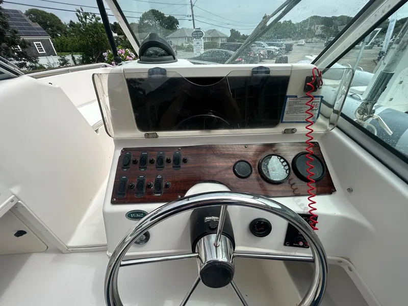 Slide: The Image of 1999 Grady-White 192 Tournament boat dashboard with steering wheel and control panel. - 7