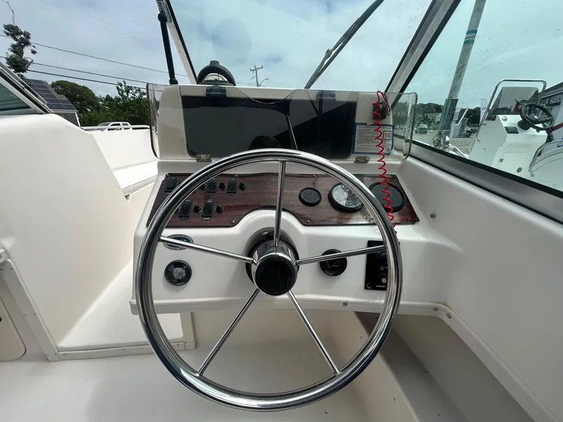 Slide: The Image of 1999 Grady-White 192 Tournament boat dashboard with steering wheel and control panel. - 8