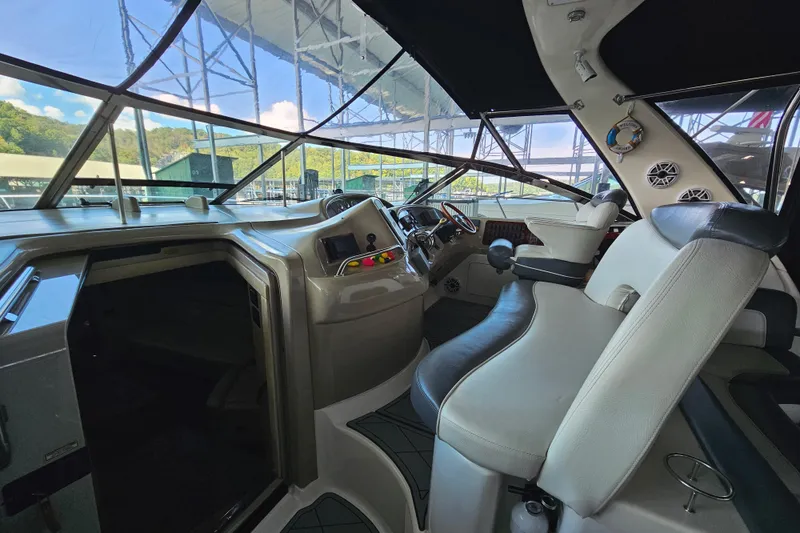 Slide: The Image of Interior view of 1999 Sea Ray 460 Sundancer yacht cockpit with leather seating and control panel. - 14