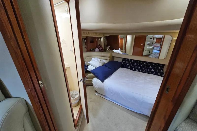 Slide: The Image of Interior cabin of 1999 Sea Ray 460 Sundancer yacht with cozy bed and nautical decor. - 17