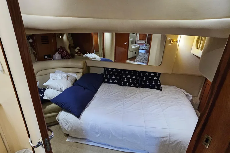 Slide: The Image of Interior cabin of 1999 Sea Ray 460 Sundancer yacht with cozy bed and nautical decor. - 18