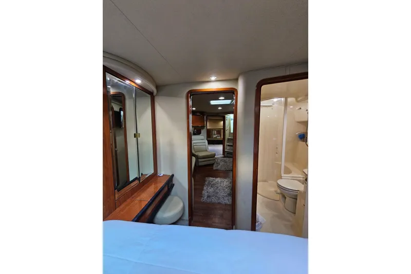 Slide: The Image of Interior of 1999 Sea Ray 460 Sundancer yacht, featuring a cozy cabin and bathroom. - 22
